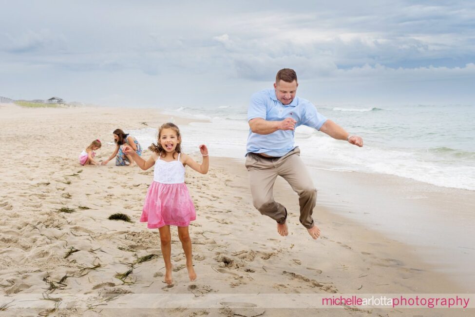 beach haven lbi nj family portrait session dad jumping with daughter