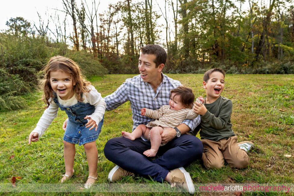 family photo of dad pulling daughter back into the photo in New Jersey