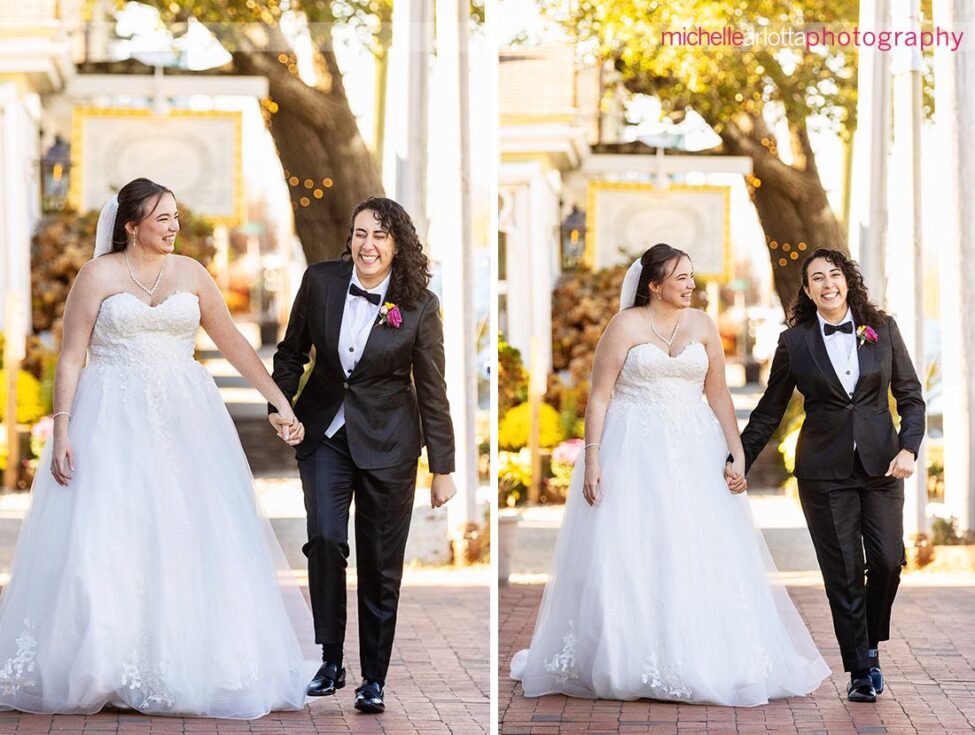 bride in white wedding gown with bride in black suit and bowtie in walking hand in hand in LBI NJ wedding