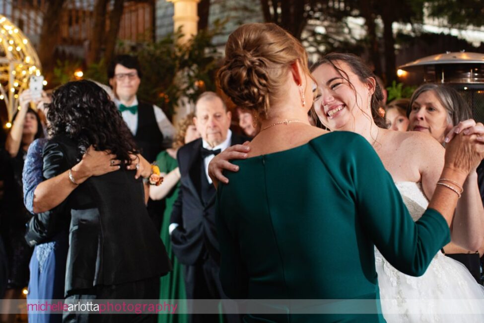 late fall outdoor garden wedding reception two brides share dances with their mothers at Gables Inn LBI NJ wedding