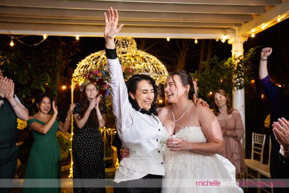 two brides at end of the night at outdoor wedding reception in garden at late fall Gables LBI NJ wedding