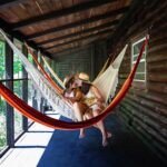 same sex couple kiss in hammock during engagement photos