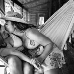 same sex couple in hammock during engagement session