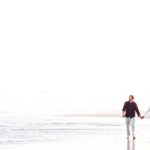 avalon new jersey couple walking on the beach together during engagement session