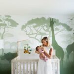 mother with newborn in giraffe-themed nursery