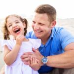 dad and daughter on beach during lbi lifestyle candid family photos