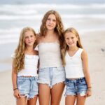 three teen sisters on lbi beach in jeans and white tops