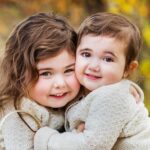 sisters cuddle up close for fall family photo