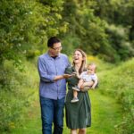 couple walks with infant among the spring nj nature