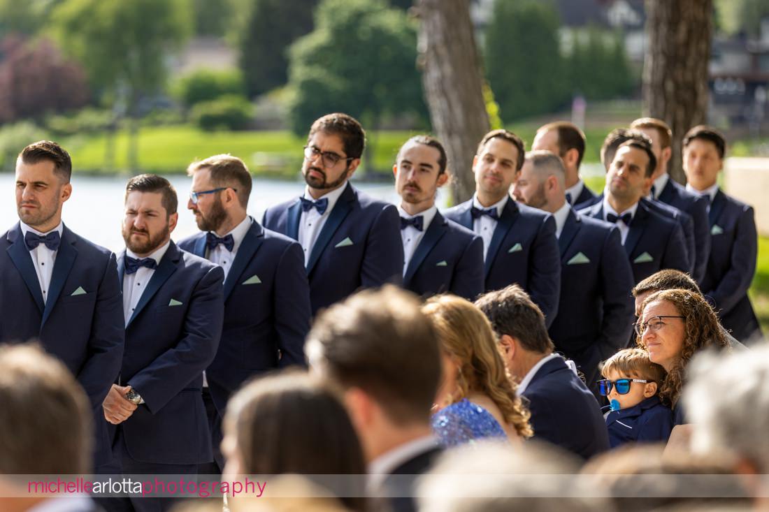 ring bearer with Ring Pop during wedding ceremony at Lake Mohawk Country Club spring lakeside 