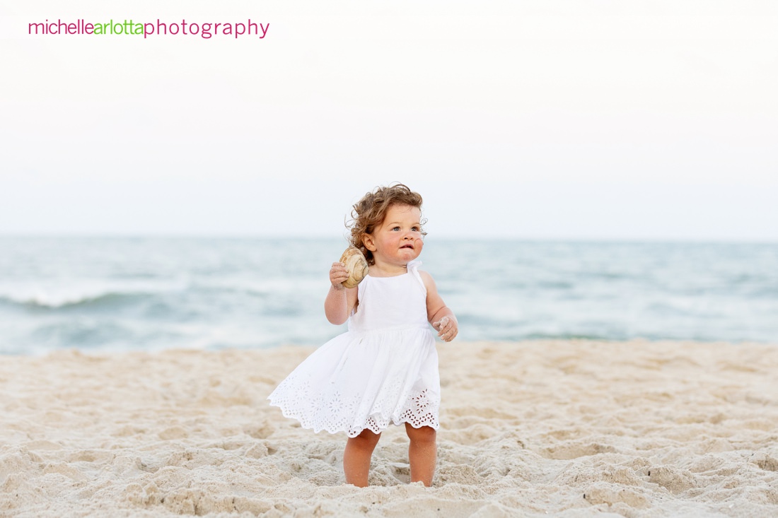 LBI beach family photos New Jersey little girl in white dress holding a sea shell
