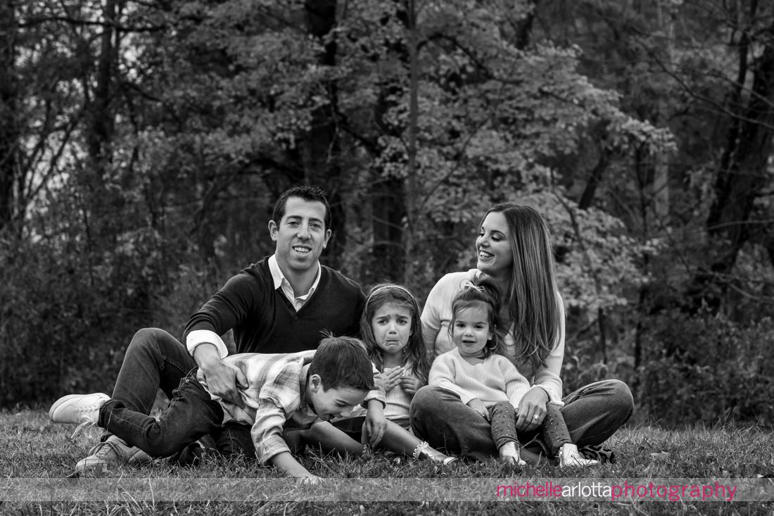 NJ fall family photo session with little girl with sad face in the middle